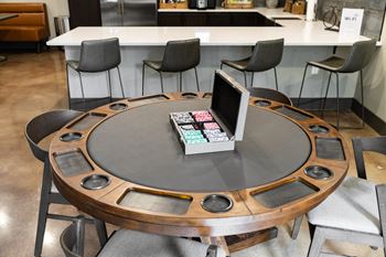 A round table with a laptop and a book on it.